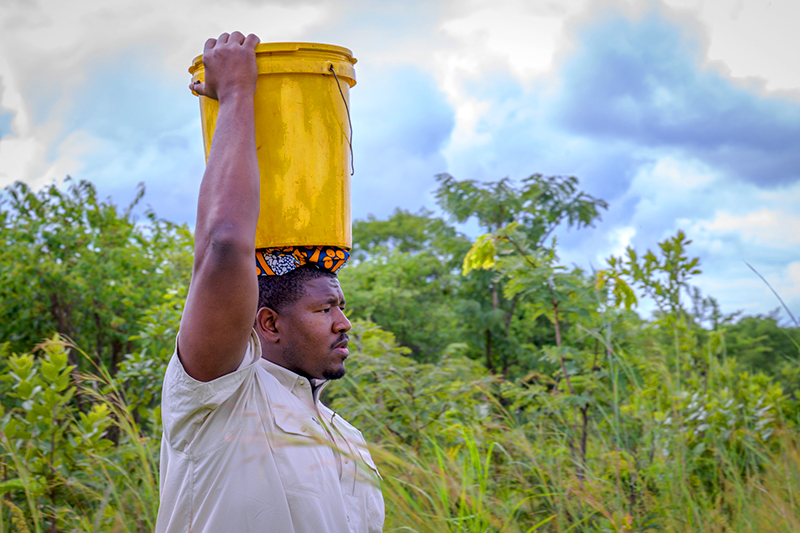 Kelvin Beachum carrying water in Lusaka, Zambia
