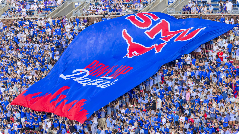 Students at a home game with a large SMU banner